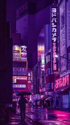 a city street at night with neon signs on the buildings and people walking in the rain