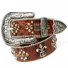 Whether you wear your Swarovski Crystals Belt with jeans or a suit, you'll be a showstopper! Each extraordinary belt is custom handcrafted in the USA from hundreds of clear or colored Swarovski crystals and rich Italian leather. The classic western Odessa belt features elegant fleur de lis embellishments embedded with copper color Swarovski crystals. The 1 1/2" wide leather belt is edged in silver ball trim with silver studs mixed with copper Swarovski crystals along the length of the belt. Engraved metal buckle and tip feature detailed filigree design. Can be worn by both men and women. Belts run ONE size small from the standard US pants size. Go one size up from your actual pants size to achieve the perfect fit. 3-4 week delivery for custom handcrafted belts. Sizes: 28", 30", 32", 34", 3 Belt With Jeans, Country Girl Boots, Womens Belts, Cowgirl Bling, Crystal Belt, Horse Accessories, Cowgirl Chic, Wide Leather Belt, Pet Fashion