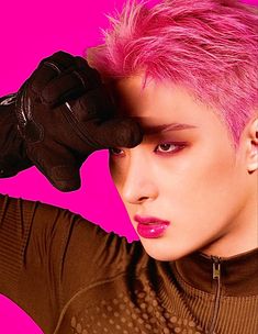 a woman with pink hair and black gloves