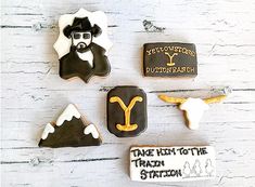 decorated cookies are arranged on a white wooden surface, with the words take them to the texas station