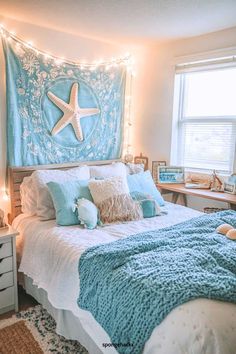 a bedroom with a starfish hanging above the bed and lights on the headboard