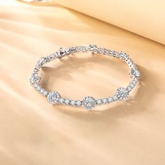 Our "Noble Allure" tennis bracelet is a masterpiece of elegance and sophistication, designed to captivate and enchant. The halo setting magnifies its beauty and brilliance. This bracelet is a mix of classic style and modern flair, perfect for anyone looking to add a touch of luxury to their look. Material: 925 Sterling Silver Length: 19cm Bracelet width: 8mm Gemstone width: 5mm Luxury Classic Bracelets With Birthstone, Halo Setting, Bracelet Online, Sterling Silver Bracelet, Tennis Bracelet, Silver Bracelets, Sterling Silver Bracelets, Birthstone, Halo