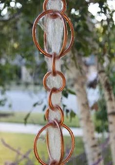 a wind chime hanging from the side of a tree