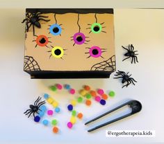 a box filled with candy and fake eyes on top of a table next to scissors