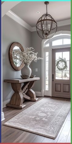 a vase with flowers on top of a table in front of a mirror and door