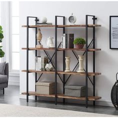 a book shelf with books, vases and other items on it in a living room