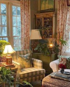 a living room filled with lots of furniture and plants on top of windowsills