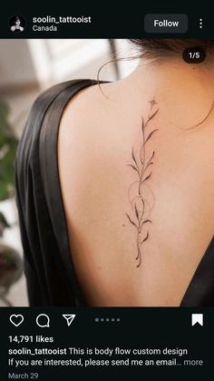 the back of a woman's neck with a flower tattoo on her left shoulder