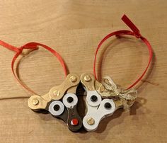 two pairs of scissors are tied together with red string and gold metal eyes on them