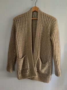 a knitted jacket hanging on a white wall