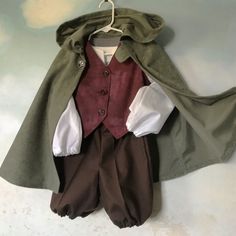 a coat and pants are hanging on a hanger