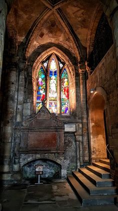 an old church with stained glass windows and stairs