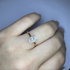 a woman's hand with a diamond ring on it