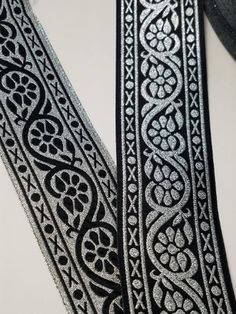 two black and white ribbons with designs on them