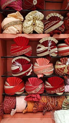 a shelf filled with lots of different types of hats