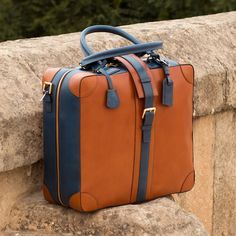 Ideal for the business traveler, the Travel Tote with the classic name tag and leather handles gives you that timeless briefcase style, measuring 14.2 x 16.5 x 6.3 inches / 36 x 42 x 16 cm. It has a main zip closure with a locking buckle strap to secure it. Designed to be functional and minimalist, it features an internal zipped pocket and a full lined interior. The removable shoulder strap makes it perfect for hands-free travel. THE DETAILS: Materials: cognac painted calf + navy painted calf Li Custom Design Shoes, Casual Tote Bag, Stylish Tote Bag, Travel Tote Bag, Handcrafted Bags, Leather Crafts, Unique Shoes, Casual Tote, Tote Bag Leather