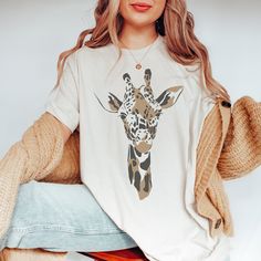 The coziest boho tshirt for the Giraffe lovers MATERIAL This t-shirt is everything you've dreamed of and more. It feels soft and lightweight, with the right amount of stretch. It's comfortable and flattering for both men and women.  ✨ Shirt sizes are Unisex, please refer to sizing chart in listing photos ✨ 100% combed and ring-spun cotton  ✨ Medium fabric weight CARE ✨ Machine wash: warm (max 40C or 105F) ✨ Do not iron ABOUT My love for design and clothing is what inspired the creation of this s Giraffe Clothes, Watercolor Giraffe, Boho Tshirt, Giraffe Shirt, Boho Tshirts, Safari Print, The Giraffe, Women Shirt, Giraffes