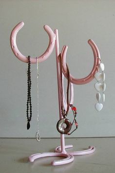 there is a pink sculpture with jewelry hanging from it