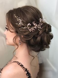 a woman wearing a tiara with flowers in it's hair, looking off to the side