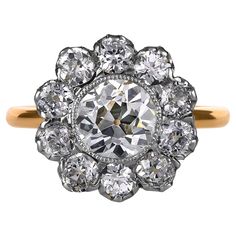 This breathtakingly beautiful, darling, early-twentieth century Edwardian Flower shaped, Cluster Ring finely hand crafted in platinum over 18 karat yellow gold. The Center Diamond is an OLD EUROPEAN Cut 1.57ct in J color, SI1 clarity, accompanied with GIA certificate. The diamond faces up very well and looks warm white in natural light , no obvious imperfections to the naked eye.. The measurements are 7.02x7.24x4.50mm, these Old Euro Rounds are so magical! The facets are large, chunky and beauti Diamond Outline, Gia Certificate, Scalloped Border, Diamond Face, Right Hand Rings, Cluster Ring, Flower Shape, Warm White, Natural Light