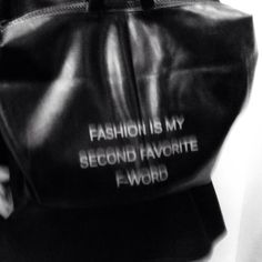 black and white photograph of a handbag with words written on it