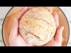 a person holding a loaf of bread in their hands