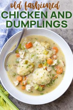 a white bowl filled with chicken and dumplings on top of a blue towel next to celery