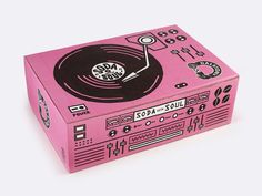 a pink record player box sitting on top of a table