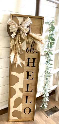 a wooden sign that says oh, hello with a bow on the front and side