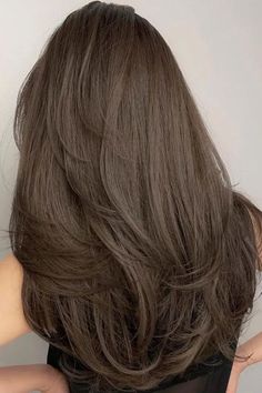 the back of a woman's head with long brown hair