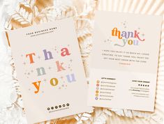 two thank you cards on top of a white paper plate with gold foil stars and confetti