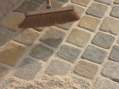 a broom sitting on top of a stone floor