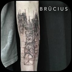 a man with a tattoo on his arm that has a drawing of a castle in it