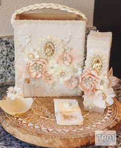 a white purse with flowers and pearls on the front is sitting on a wooden stand