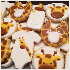 decorated cookies in the shape of giraffes and baby ones are on display