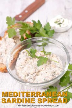 a bowl of food with bread and parsley on the side that says mediterranean sardine spread