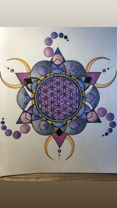 a drawing of a flower of life on paper