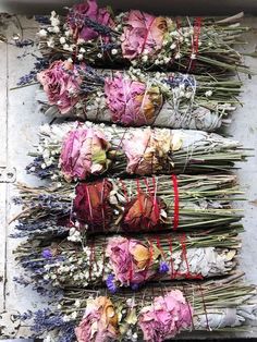 several bundles of dried flowers sitting on top of each other