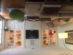 a living room filled with furniture and a flat screen tv