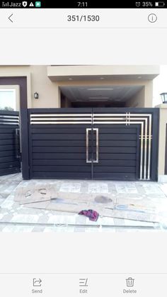 an image of a house that is being remodeled with the front gate painted black and silver