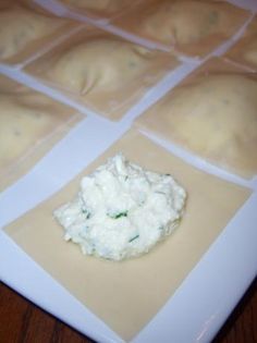 some food is laying out on a white plate with squares in the middle and one small piece of cream