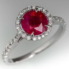 This beautiful ring is centered with one (1) round mixed cut natural ruby set into a four-prong setting and bordered with twenty (20), prong set, round brilliant cut diamonds. The top face of the eternity style shank is accented with thirty-two (32), prong set, round brilliant cut diamonds. The side faces of the ring are each accented with six (6), prong set, round brilliant cut diamonds. The ring measures 9.1mm at the top, rises 6.2mm above the finger, tapering to 1.6mm wide and 0.9mm thick at Ruby Set, Ruby Engagement Ring, Wedding Anniversary Gift, Ruby Diamond, Beautiful Ring, Natural Ruby, Ring Wedding, Solitaire Engagement, Round Brilliant Cut Diamond