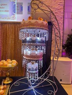 a table topped with lots of cakes and cupcakes