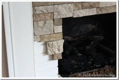 a fire place with rocks on the mantle