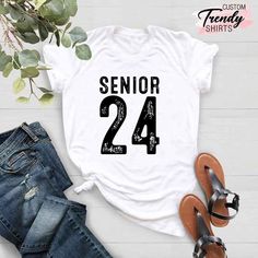 "Senior 2024 Shirt, 2024 Graduation Gift, College High School Senior Shirt Gifts, Class of 2024 Shirt, Senior 24, Graduation Team Gift Shirt ----- How To Order ----- 1-) Please, check and review all the photos. 2-) Choose your t-shirt size and color. *Different styles of shirts may have different shades of same color choice due to different manufacturer brands. *For this reason, we recommend you to match shirts from the same styles if you want precisely matching colors (ex. Unisex, V-necks, Todd White Shirt With Letter Print For Graduation, White Graphic Print Shirt For College Events, Senior Class Shirts, Class Shirt, Senior Shirts, Graduation Year, 2024 Graduation, Class Of 2024, Kids Graphic Tees