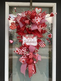 a valentine's day wreath hanging on the front door for someone to welcome their loved one