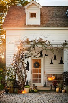 a house decorated for halloween with pumpkins and decorations