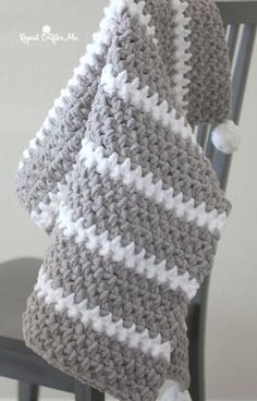 a crocheted blanket sitting on top of a chair