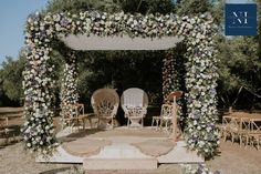 an outdoor wedding setup with chairs and flowers