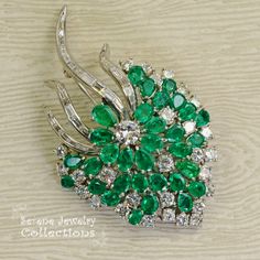 Stunning burst of vivid green emeralds and sparkly white diamonds covering all the surfaces of this beautiful platinum vintage brooch! Total Weight: 29.15 grams Size: 2.5 inch tall, 1.5 inch wide Precious Metal: Platinum Precious stones: -Emeralds: QTY: 31, 2.7mmx4.7mm to 4.2mmx6.3mm size, 7.5 carats -Diamonds: 29 rounds, 20 baguettes, 6 carats Luxury Green Brooch For Anniversary, Luxury Green Brooches For Anniversary, Luxury Green Brooch For Formal Occasions, Luxury Green Brooches For Wedding, Fine Jewelry Green Gemstone Brooches, Green Diamond Wedding Brooches, Elegant Green Diamond Brooch, Fine Jewelry Green Brooch For Anniversary, Fine Jewelry Green Brooches For Anniversary